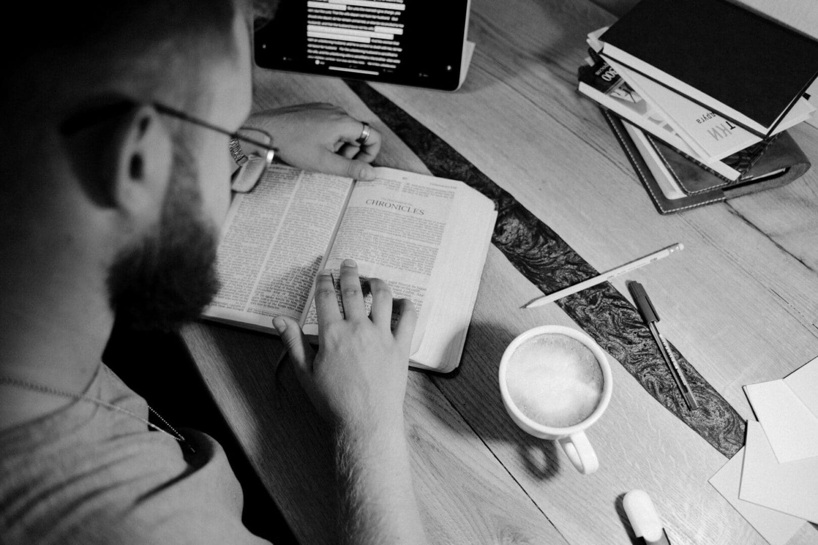 A person is reading a book on the table