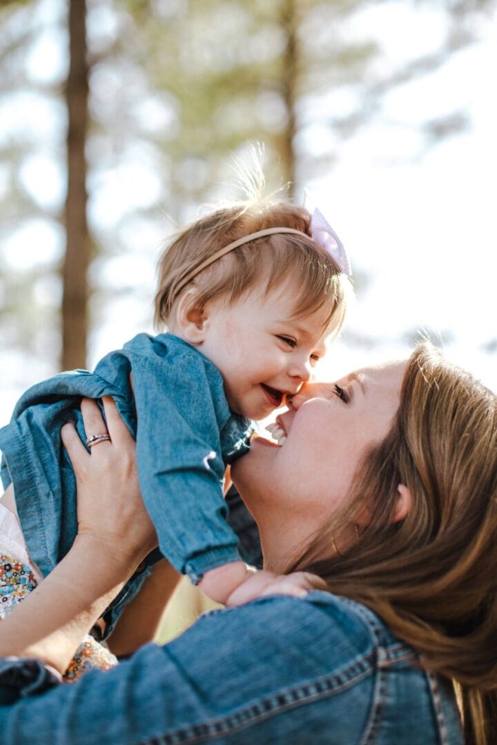 A woman holding a baby in her arms.