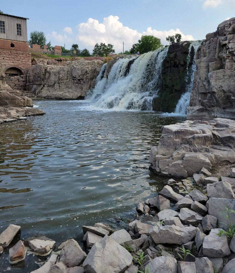 A waterfall with rocks and water flowing over it.