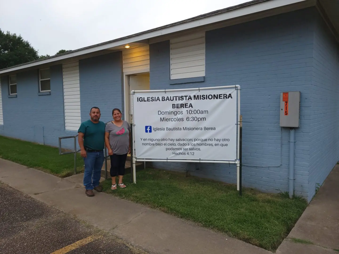 A man and woman standing in front of a building.